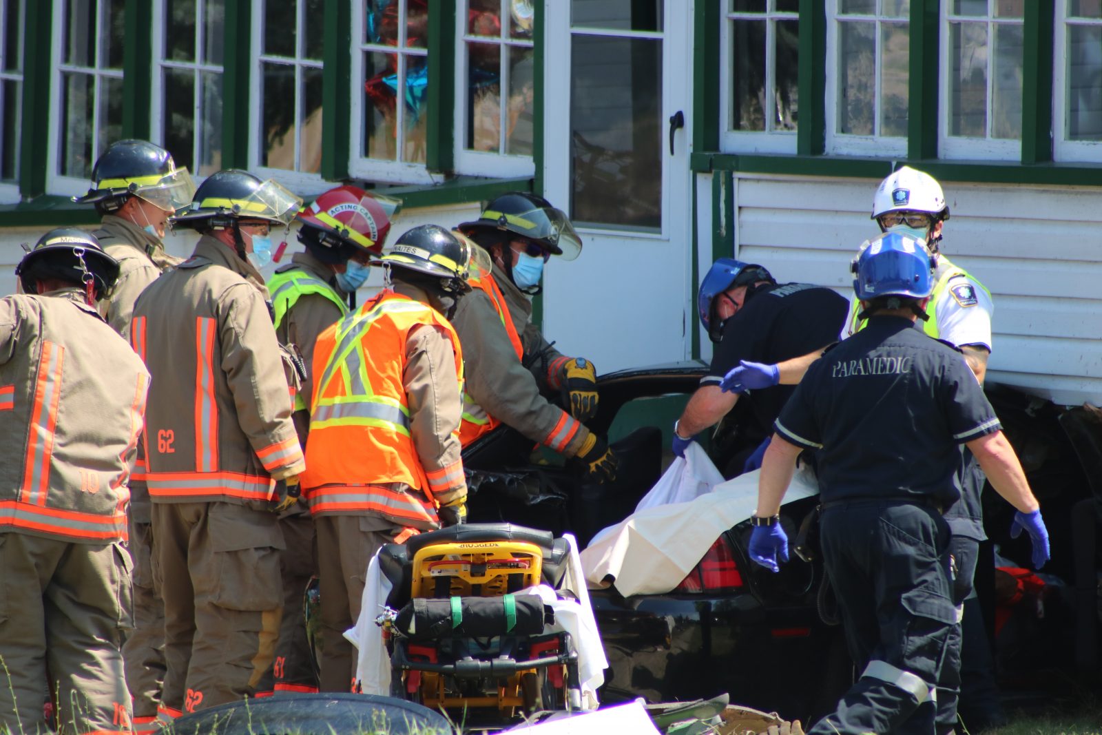 Road open after car collides with home, two people taken to hospital